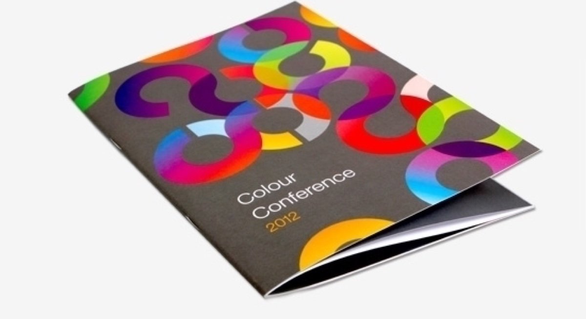 A saddle-stitched booklet with a colourful printed cover