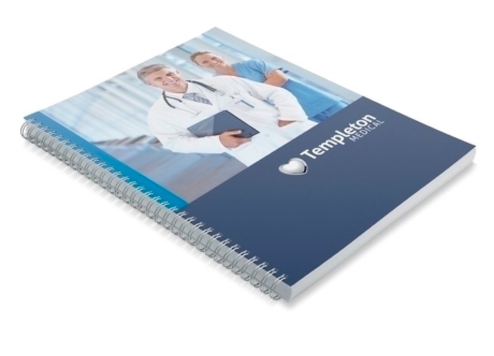 A wire-bound corporate report with a printed cover