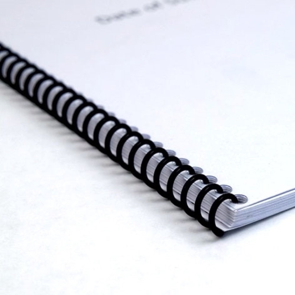 Close-up of a black wire-bound document produced by Copyprint